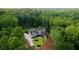 Expansive aerial view of the property showcasing the home's layout, pool, and wooded surroundings at 1084 Wrights Mill Rd, Canton, GA 30115