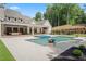 Expansive backyard with pool, lounge area, and covered outdoor kitchen at 1084 Wrights Mill Rd, Canton, GA 30115