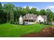 Expansive backyard featuring a pool, lush lawn, mature trees, and an inviting outdoor living space at 1084 Wrights Mill Rd, Canton, GA 30115