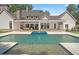 Beautiful backyard features an in-ground pool, covered patio, and well-maintained lawn at 1084 Wrights Mill Rd, Canton, GA 30115