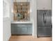 Stylish bar area with custom cabinets, lighting, shelving, and a modern refrigerator at 1084 Wrights Mill Rd, Canton, GA 30115