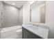 Bathroom with green vanity, marble countertop, and tiled shower at 1084 Wrights Mill Rd, Canton, GA 30115