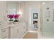 Bathroom view featuring marble counters, double sinks, brass fixtures and a glass shower with decorative tile at 1084 Wrights Mill Rd, Canton, GA 30115