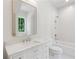 Bathroom offers a vanity with stone countertop, tile floor and shower over tub, creating a spa-like retreat at 1084 Wrights Mill Rd, Canton, GA 30115