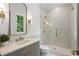 Bright bathroom with sleek marble shower, modern vanity, and stylish lighting, offering a luxurious spa-like experience at 1084 Wrights Mill Rd, Canton, GA 30115