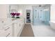 Bathroom with standalone tub, glass shower, double sinks and white cabinets with brass hardware at 1084 Wrights Mill Rd, Canton, GA 30115