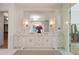 Bright bathroom features a double vanity with marble counters, decorative hardware, and glass-enclosed shower at 1084 Wrights Mill Rd, Canton, GA 30115