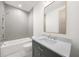 Well-appointed bathroom with marble countertop, gray vanity, tub, and sleek shower fixtures at 1084 Wrights Mill Rd, Canton, GA 30115