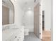 Bright bathroom with dual vanities, penny tile floors, and a shower-tub combo at 1084 Wrights Mill Rd, Canton, GA 30115