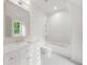 Charming bathroom with white marble countertop, framed mirror, and patterned tile flooring at 1084 Wrights Mill Rd, Canton, GA 30115