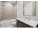 Elegant bathroom with a tub, neutral tiles, and a modern vanity with marble countertop at 1084 Wrights Mill Rd, Canton, GA 30115