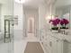 Elegant bathroom features marble floors, double vanity with storage, and separate glass-enclosed shower and tub at 1084 Wrights Mill Rd, Canton, GA 30115