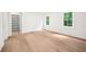 Bright, airy bedroom with hardwood floors, two windows, and a closet providing ample storage at 1084 Wrights Mill Rd, Canton, GA 30115