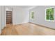 Bedroom features hardwood floors, closet, and two windows, offering a functional and inviting space at 1084 Wrights Mill Rd, Canton, GA 30115