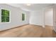 Bedroom offers hardwood floors, two windows, and trim detail, creating a comfortable and welcoming atmosphere at 1084 Wrights Mill Rd, Canton, GA 30115
