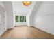 Bright bedroom featuring beautiful hardwood floors, large windows, and custom wall paneling at 1084 Wrights Mill Rd, Canton, GA 30115