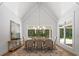 Dining room with high ceilings, a large window, and a table with seating for eight at 1084 Wrights Mill Rd, Canton, GA 30115