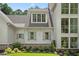 Elegant exterior showcases large windows, light shutters, brick accents, and lush landscaping at 1084 Wrights Mill Rd, Canton, GA 30115