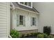 Charming home exterior with light shutters, brick foundation, and meticulously maintained landscaping at 1084 Wrights Mill Rd, Canton, GA 30115