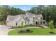 Beautiful two-story home boasting manicured lawn, lush landscaping, and a charming covered porch at 1084 Wrights Mill Rd, Canton, GA 30115