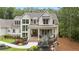 Stunning two-story home with white siding, manicured landscaping, and a welcoming front porch at 1084 Wrights Mill Rd, Canton, GA 30115