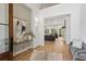 Grand foyer with hardwood floors, elegant console table, and open view to the living room with chandelier and natural light at 1084 Wrights Mill Rd, Canton, GA 30115