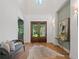Spacious front foyer with high ceiling, double doors, hardwood floor, and seating is warm and inviting at 1084 Wrights Mill Rd, Canton, GA 30115