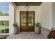 Elegant double front doors with glass panes, flanked by planters, on a brick porch at 1084 Wrights Mill Rd, Canton, GA 30115
