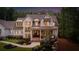 Charming two-story home features a brick and siding exterior, manicured lawn and professional landscaping at 1084 Wrights Mill Rd, Canton, GA 30115