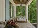 Inviting front porch featuring a comfortable swing, perfect for enjoying the serene surroundings at 1084 Wrights Mill Rd, Canton, GA 30115