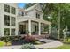 Inviting front porch with brick flooring, swing, and stylish columns enhancing curb appeal at 1084 Wrights Mill Rd, Canton, GA 30115