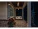 Inviting front porch with a cozy swing, brick flooring, and a beautifully stained wood ceiling at 1084 Wrights Mill Rd, Canton, GA 30115