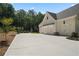 Spacious three-car garage with a wide driveway and well-manicured landscaping at 1084 Wrights Mill Rd, Canton, GA 30115