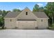 Spacious three-car garage with a wide driveway and well-manicured landscaping at 1084 Wrights Mill Rd, Canton, GA 30115