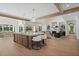 Open-concept great room with kitchen island, dining area, and fireplace with raised hearth at 1084 Wrights Mill Rd, Canton, GA 30115