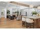 Open-concept great room with kitchen island, dining area, and fireplace with raised hearth at 1084 Wrights Mill Rd, Canton, GA 30115