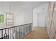 Bright hallway featuring wood floors, modern light fixture, and geometric paneled walls at 1084 Wrights Mill Rd, Canton, GA 30115