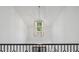 Open hallway featuring high ceilings with modern light fixture and iron railing at 1084 Wrights Mill Rd, Canton, GA 30115