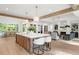 Open kitchen with a large island, modern lighting, and a view of the dining area at 1084 Wrights Mill Rd, Canton, GA 30115