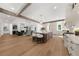 Open-concept kitchen with a large island, wooden beams, stainless steel appliances, and hardwood floors at 1084 Wrights Mill Rd, Canton, GA 30115