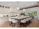 Modern kitchen with stone island, stainless steel appliances, and an adjacent dining area at 1084 Wrights Mill Rd, Canton, GA 30115