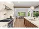 Well-appointed kitchen featuring professional appliances, custom cabinetry, and a view into the outdoor dining area at 1084 Wrights Mill Rd, Canton, GA 30115
