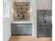 Gourmet kitchen featuring custom cabinets, beverage center, and a stainless steel refrigerator at 1084 Wrights Mill Rd, Canton, GA 30115