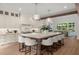 Large kitchen with an island, modern appliances, white cabinets, and hardwood floors at 1084 Wrights Mill Rd, Canton, GA 30115