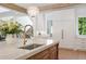 Kitchen island with marble countertop, stainless steel sink, and seating for two at 1084 Wrights Mill Rd, Canton, GA 30115