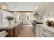 Bright and airy kitchen with white cabinetry, a large island, and stainless steel appliances, perfect for culinary enthusiasts at 1084 Wrights Mill Rd, Canton, GA 30115