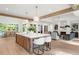 Open kitchen showcases a large island with seating, wooden beams, and an open flow to the dining and living areas at 1084 Wrights Mill Rd, Canton, GA 30115