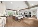 Bright, open kitchen features a large island, modern appliances, and seamless transition to the living area with exposed beams at 1084 Wrights Mill Rd, Canton, GA 30115