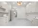 Bright laundry room featuring white cabinets, marble countertops, and a view into the home's interior at 1084 Wrights Mill Rd, Canton, GA 30115