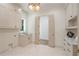 Bright laundry room with marble countertops, ample cabinets and folding doors at 1084 Wrights Mill Rd, Canton, GA 30115